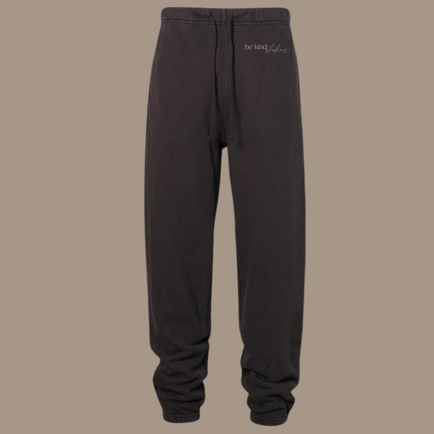 Scrunch leg sweat pants with the words "be kind studios" embroidered on the front.