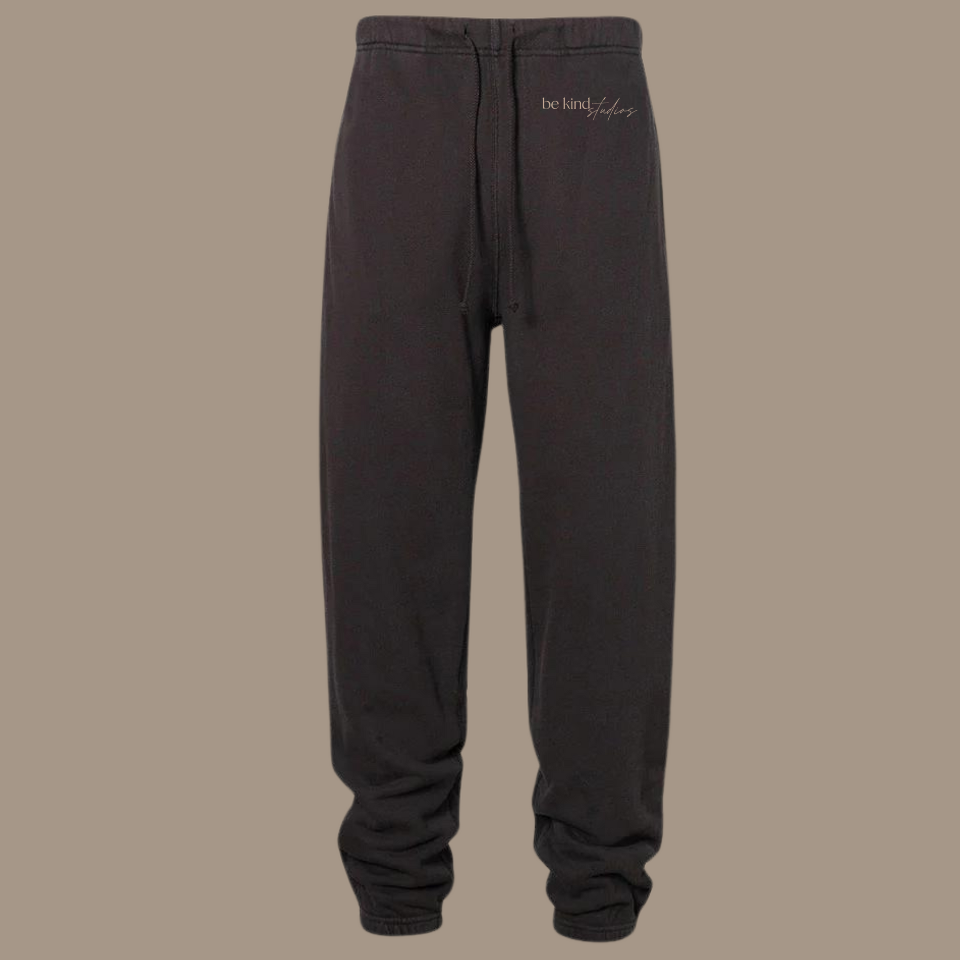 Scrunch leg sweat pants with the words "be kind studios" embroidered on the front.