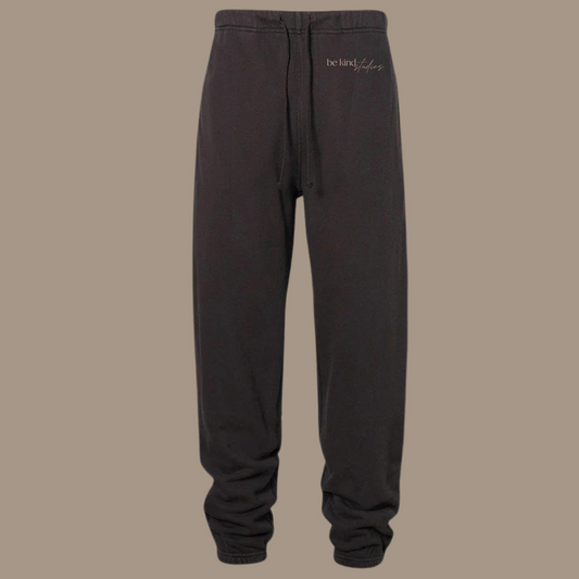 Scrunch leg sweat pants with the words "be kind studios" embroidered on the front.