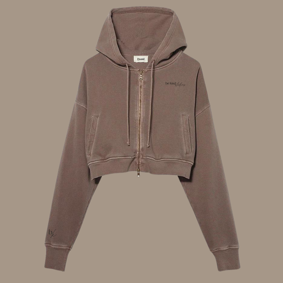 Crop zip hoodie with the words "be kind studios" embroidered on the front.