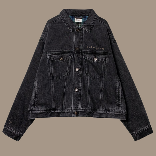 Button down black jean jacket with the words "be kind studios" embroidered on the front.