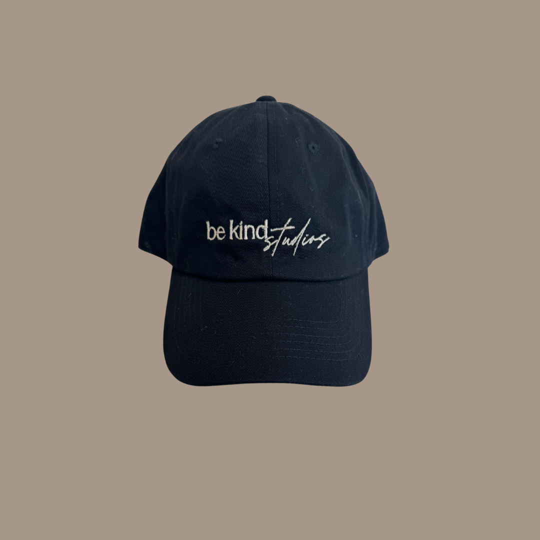 Dad hat with the words "be kind studios" embroidered on the front.