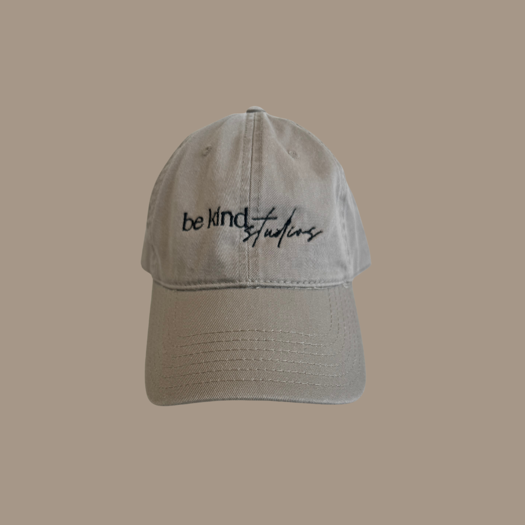 Dad hat with the words "be kind studios" embroidered on the front.