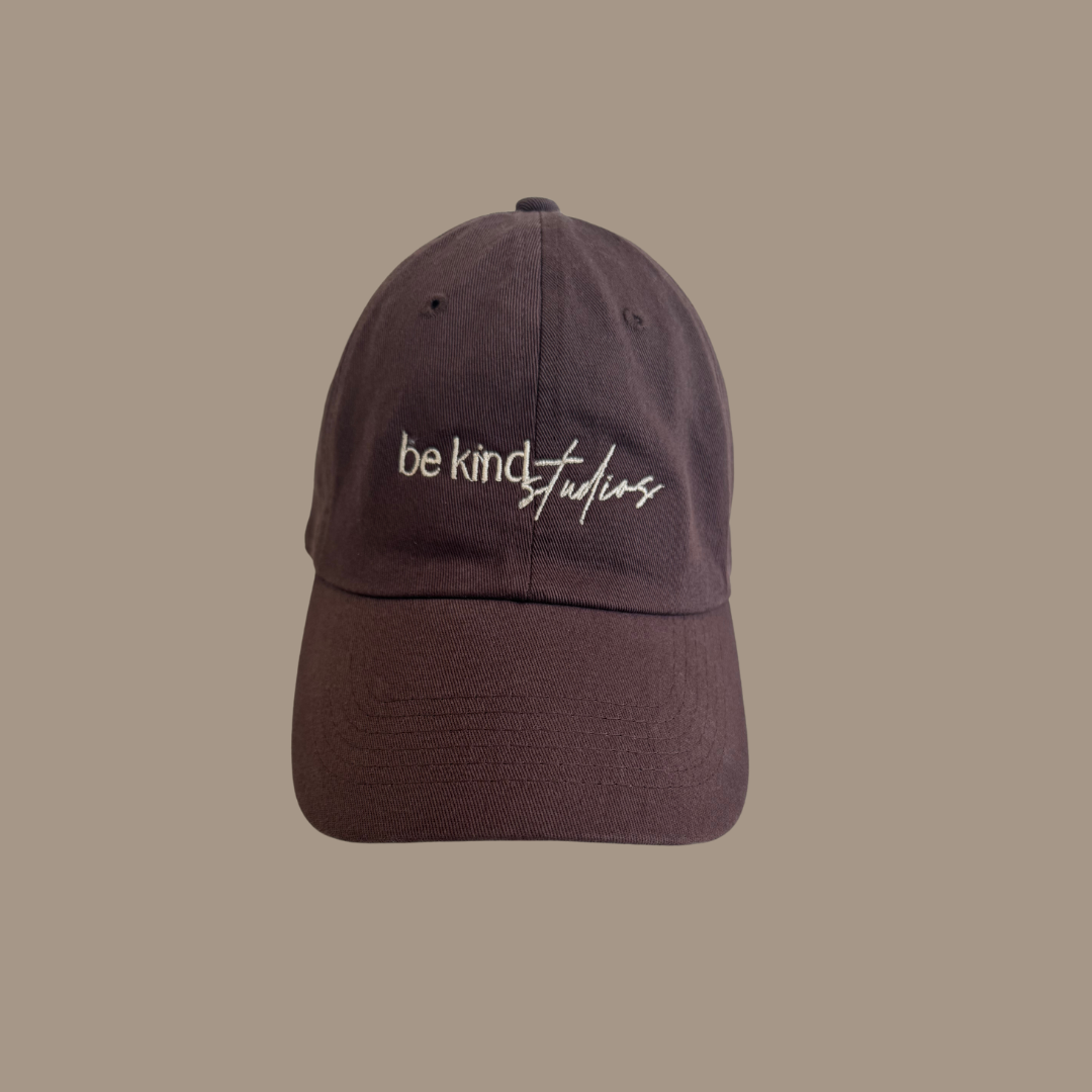 Dad hat with the words "be kind studios" embroidered on the front.