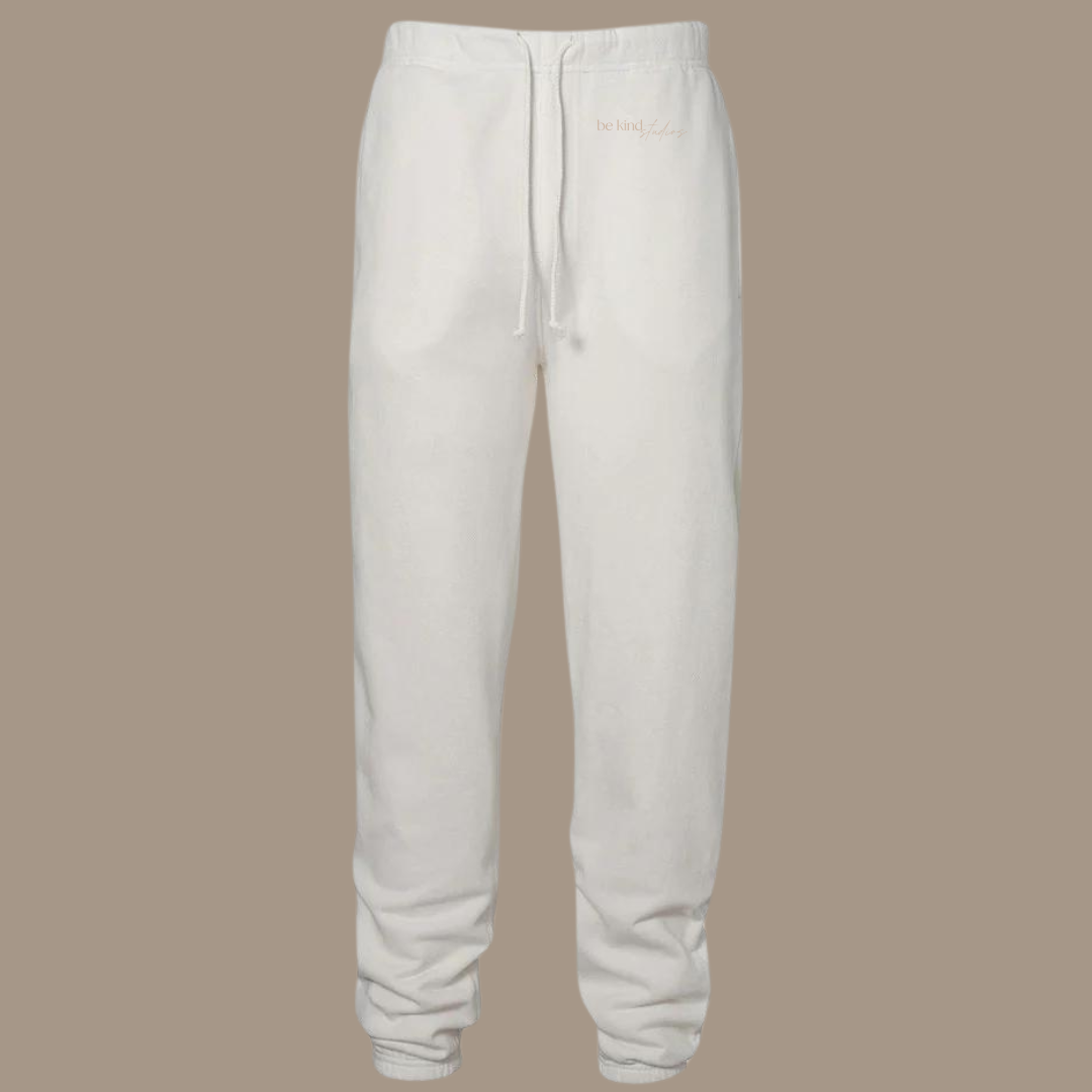 Scrunch leg sweat pants with the words "be kind studios" embroidered on the front.