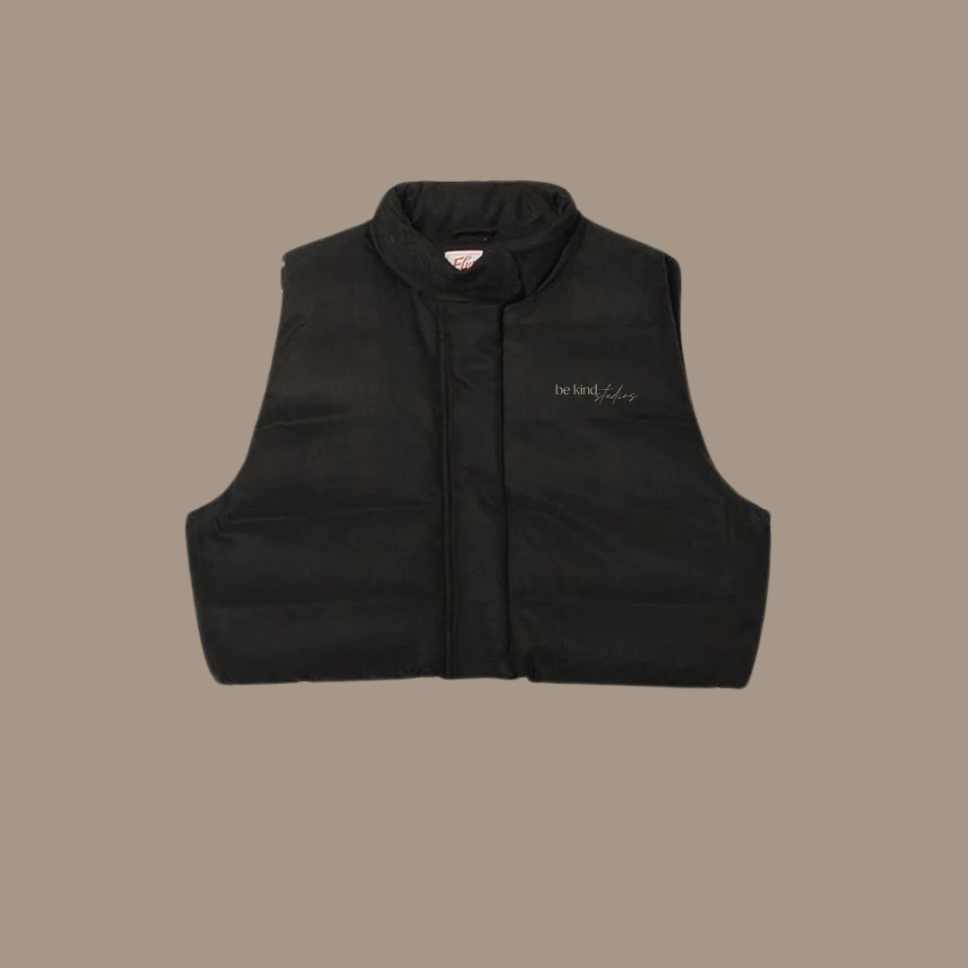 Crop puffer with "be kind studios" embroidered on front
