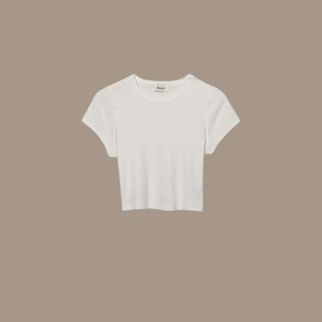 Crop tee with the words "be kind studios" embroidered on the front.