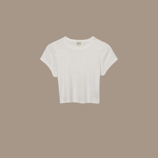 Crop tee with the words "be kind studios" embroidered on the front.