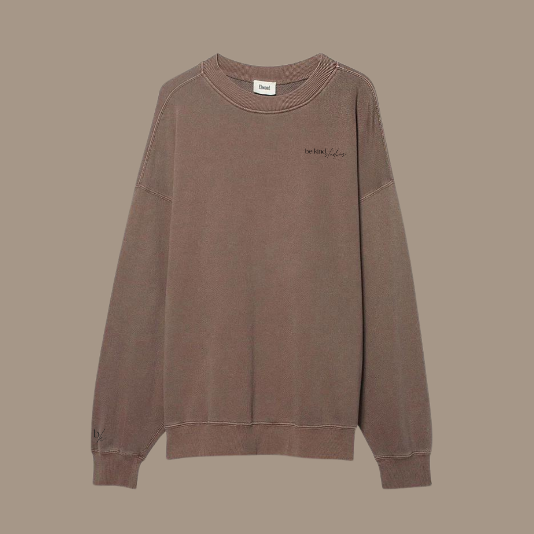 Oversized crew neck with the words "be kind studios" embroidered on the front.