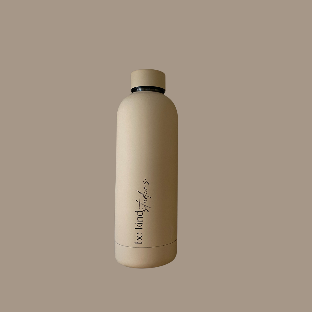 Stainless steel water bottle with screw off cap. Logo "be kind studios" printed on the side