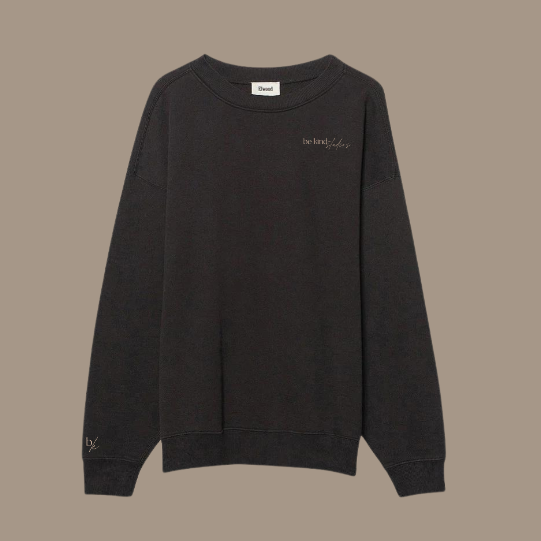 Oversized crew neck with the words "be kind studios" embroidered on the front.