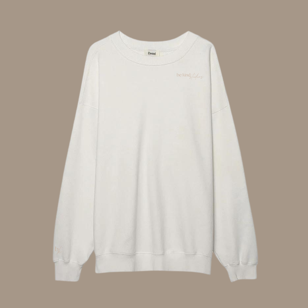 Oversized crew neck with the words "be kind studios" embroidered on the front.