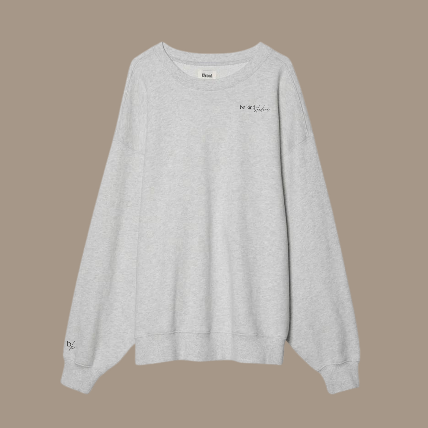 Oversized crew neck with the words "be kind studios" embroidered on the front.