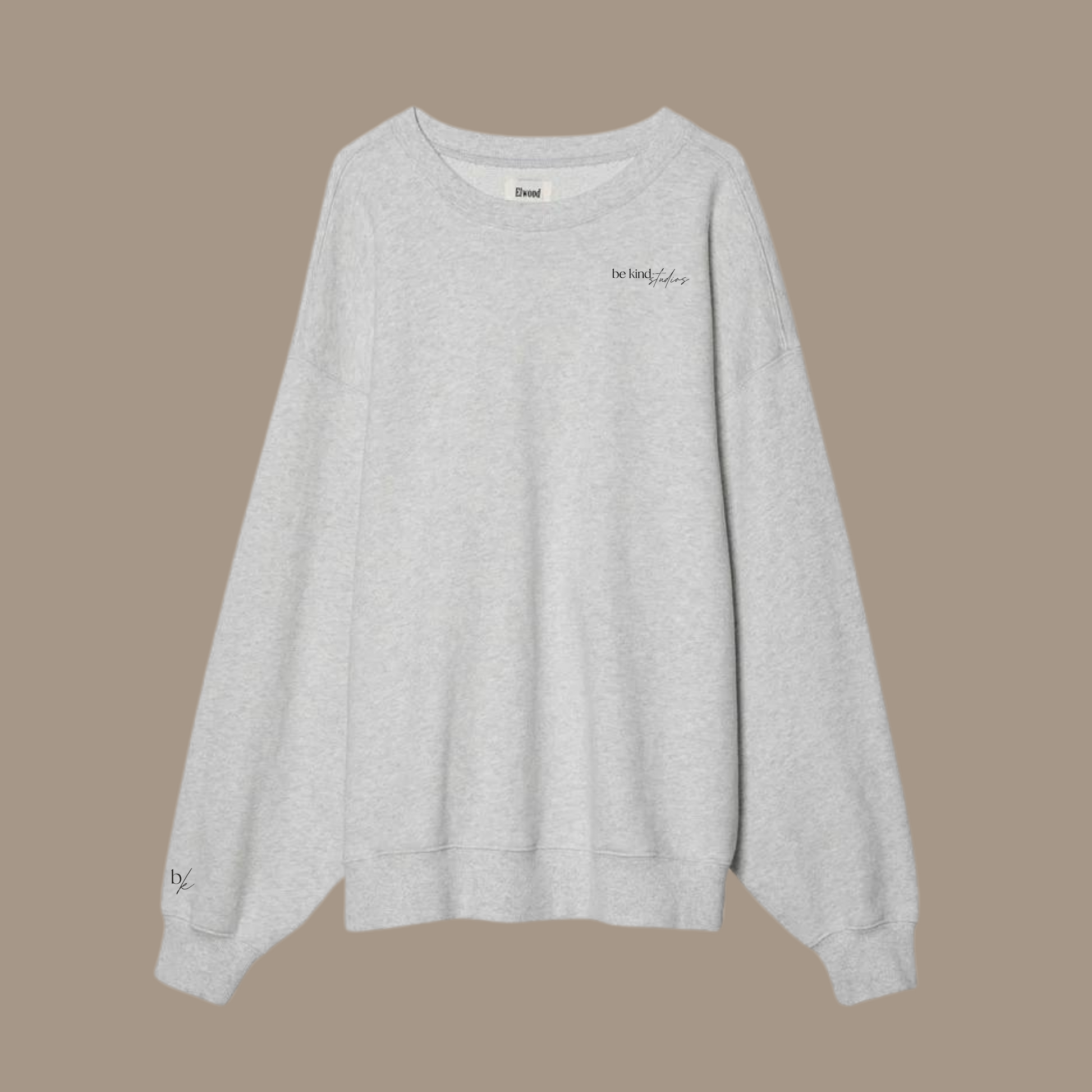 Oversized crew neck with the words "be kind studios" embroidered on the front.